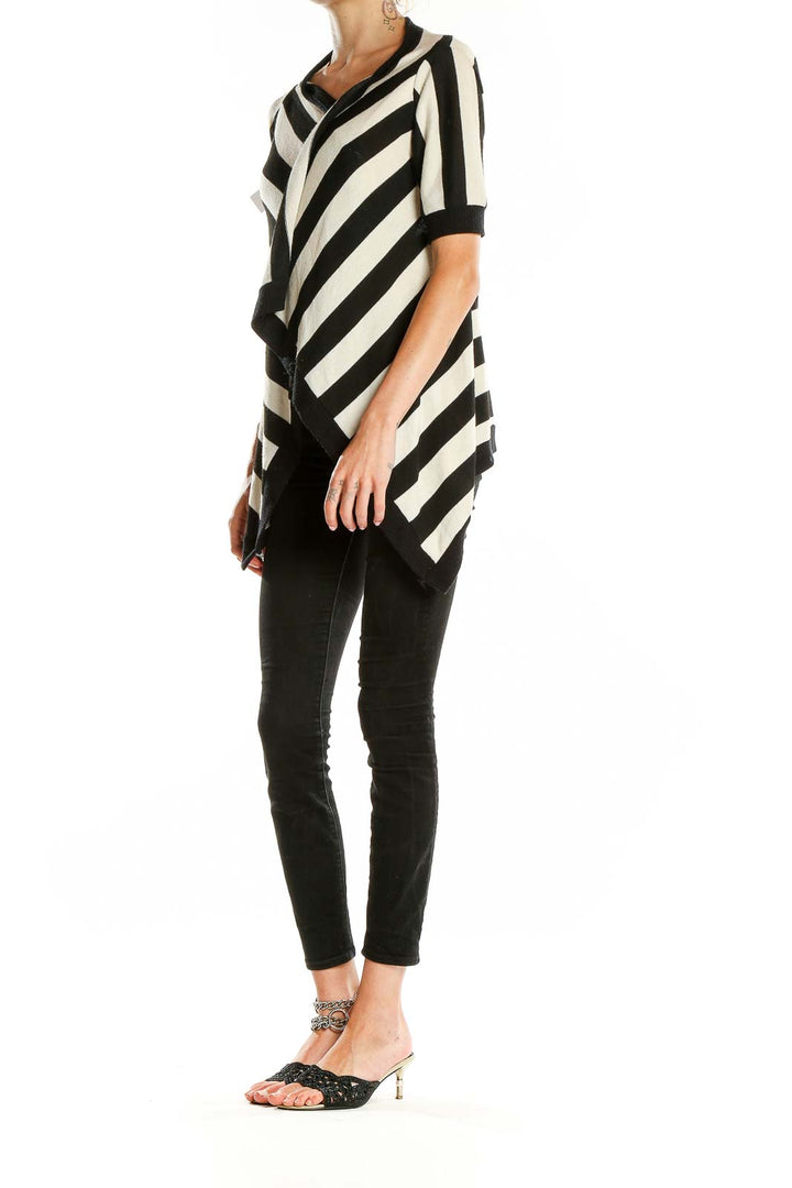 Front view of Silence + Noise Black and White Striped Asymmetrical Knit Top