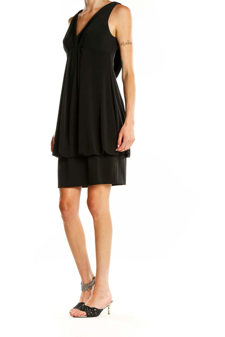 Front view of Eliza J black cocktail dress with V-neck and bubble hem