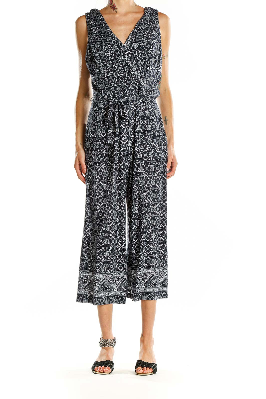 Front view of SANDRA DARREN black and white geometric print jumpsuit with V-neck and cropped wide legs