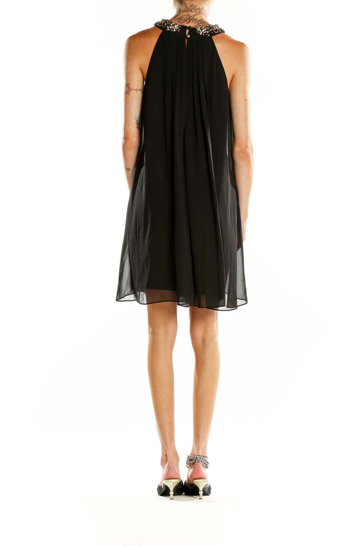 Back view of Vince Camuto black chiffon cocktail dress showing open back design