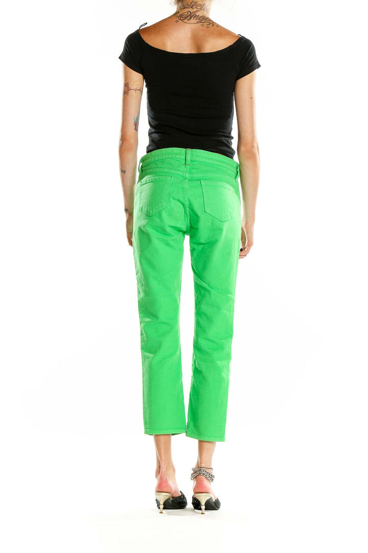 Back view of Kate Spade green cropped denim jeans on model