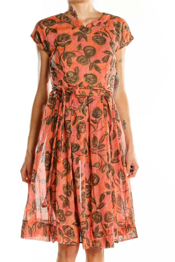 Front view of coral floral print belted dress by Jean Lang