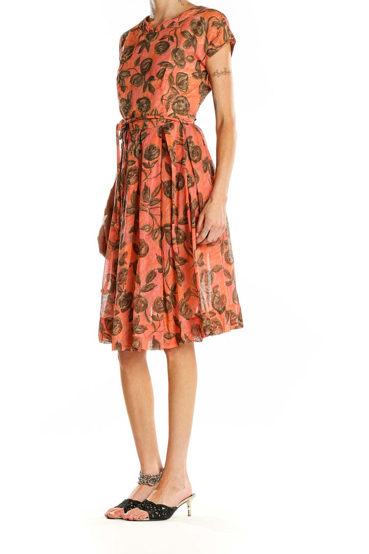 Front view of coral floral print belted dress by Jean Lang