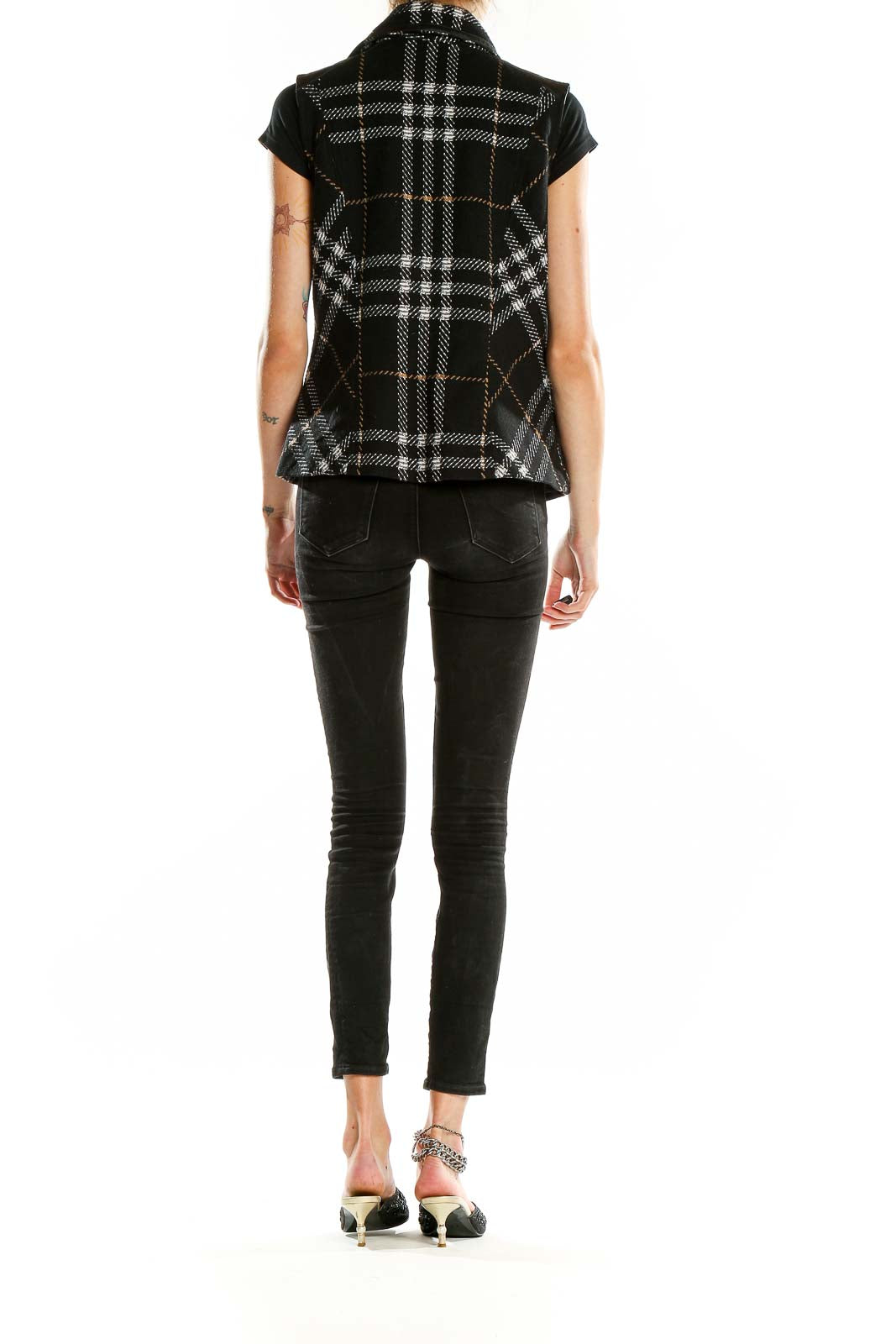 Back view of Cabi Black Plaid Asymmetrical Zip Vest on model