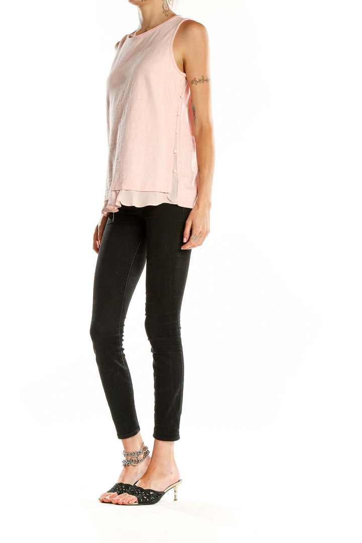 Front view of blush pink LOFT sleeveless tank top with layered ruffle hem