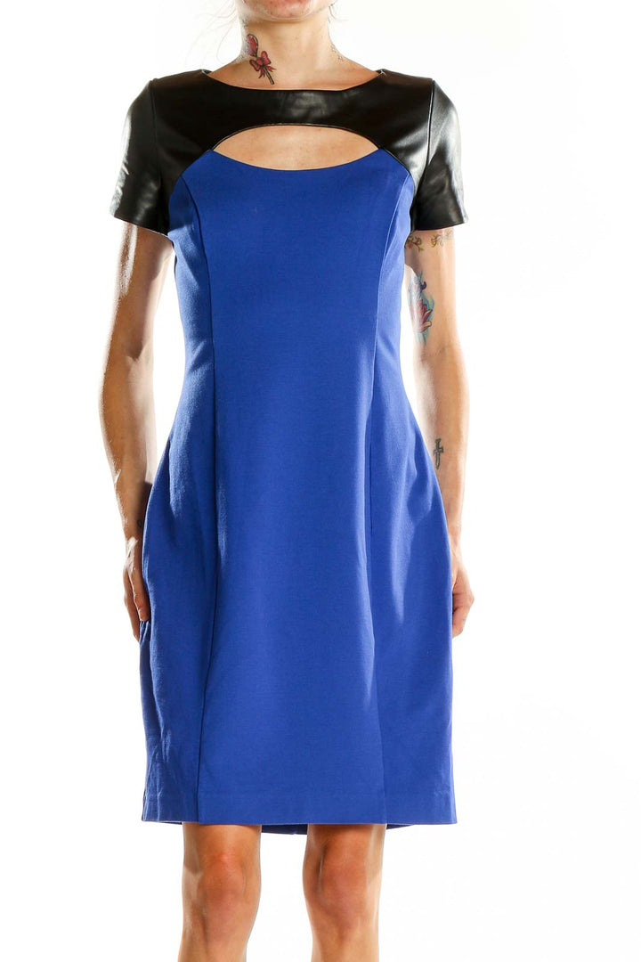 Front view of blue Nue by Shani cocktail dress with black leather accents and cutout detail