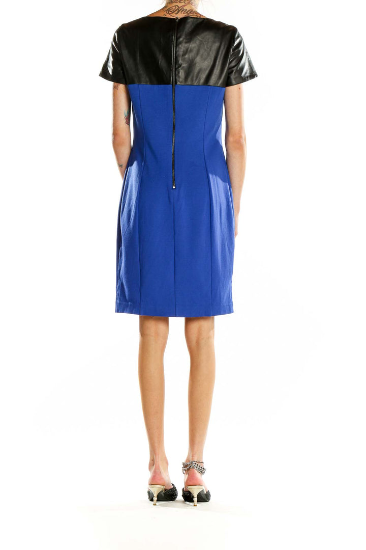 Back view of blue Nue by Shani cocktail dress showing zipper closure and leather yoke