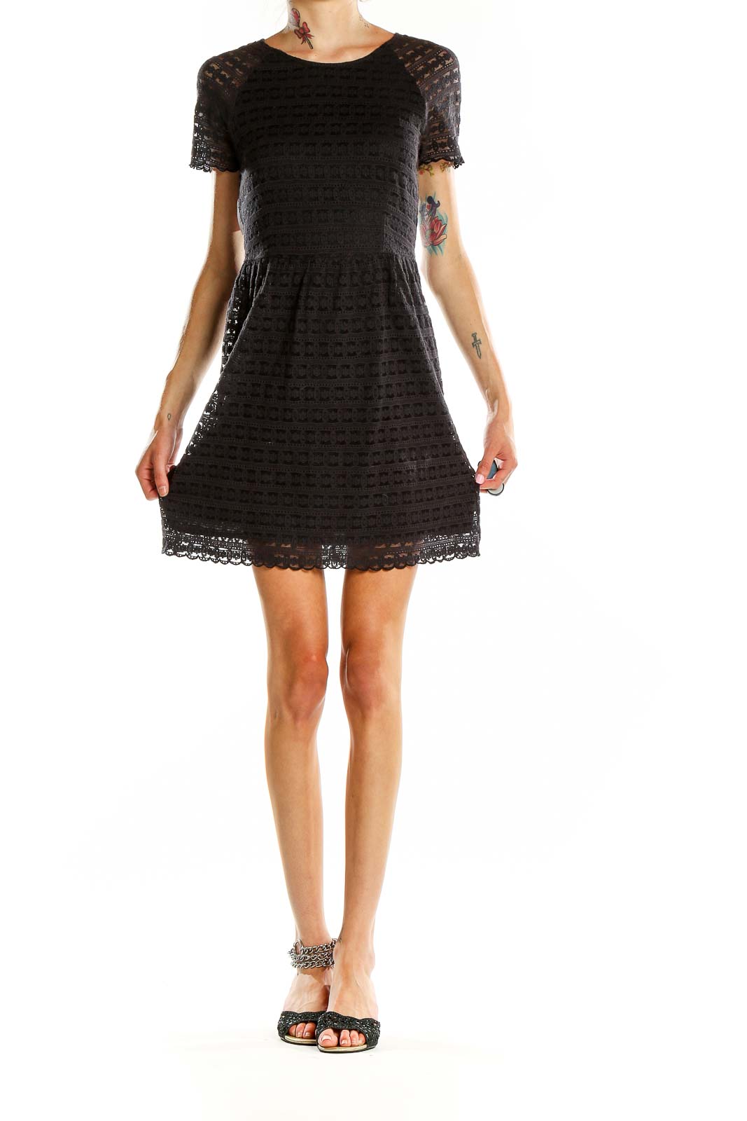 Front view of Free People black lace short-sleeve mini dress on model