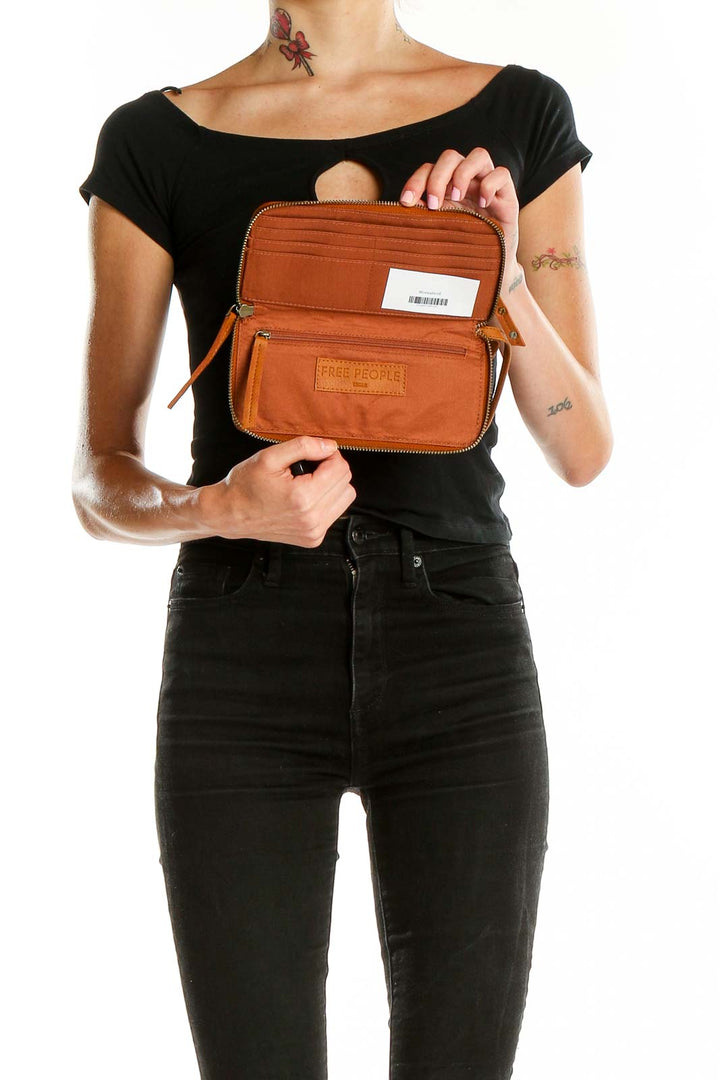 Tan vegan leather zip clutch from Free People, interior view