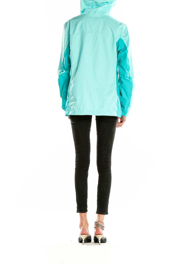 Back view of mint green Columbia hooded rain jacket on model