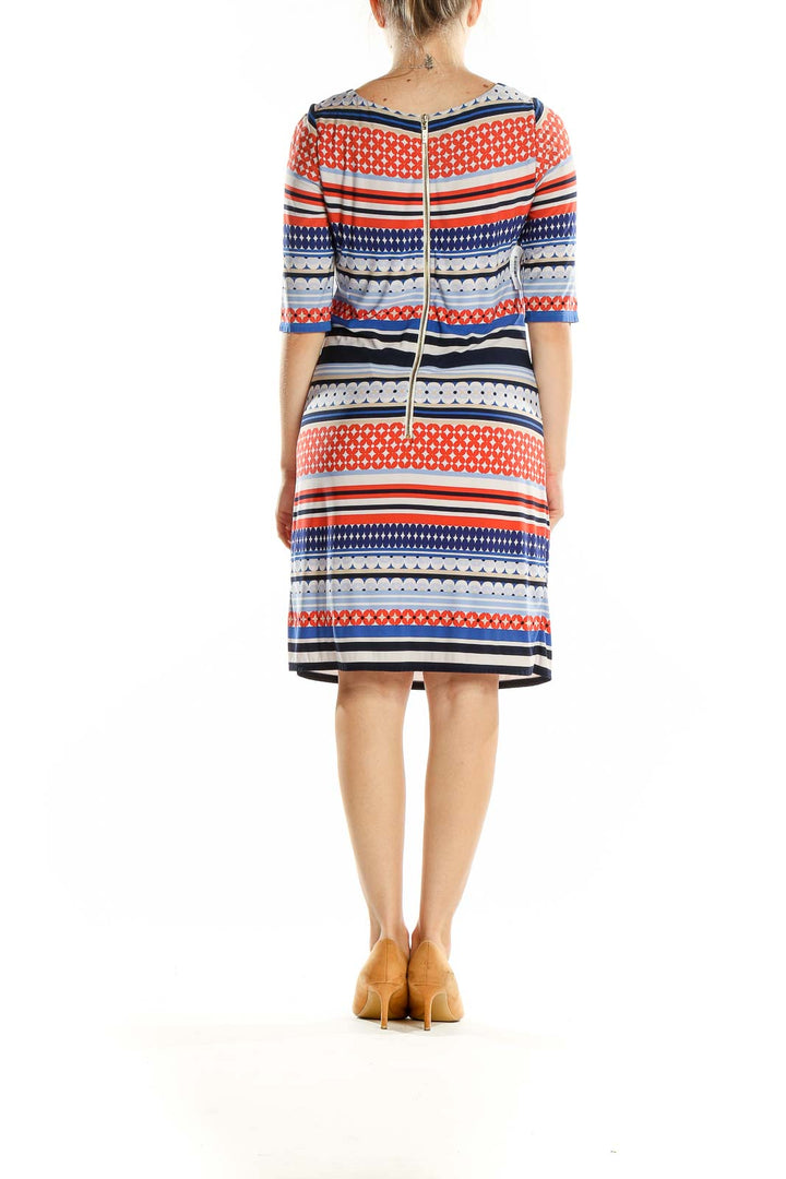 Back view of Eliza J blue and orange geometric print fitted dress with zipper closure