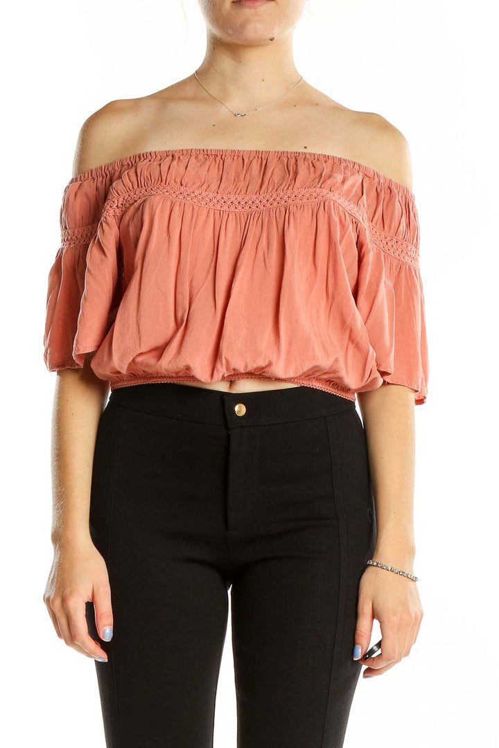 Front view of Kendall + Kylie coral off-shoulder cropped top with crochet trim