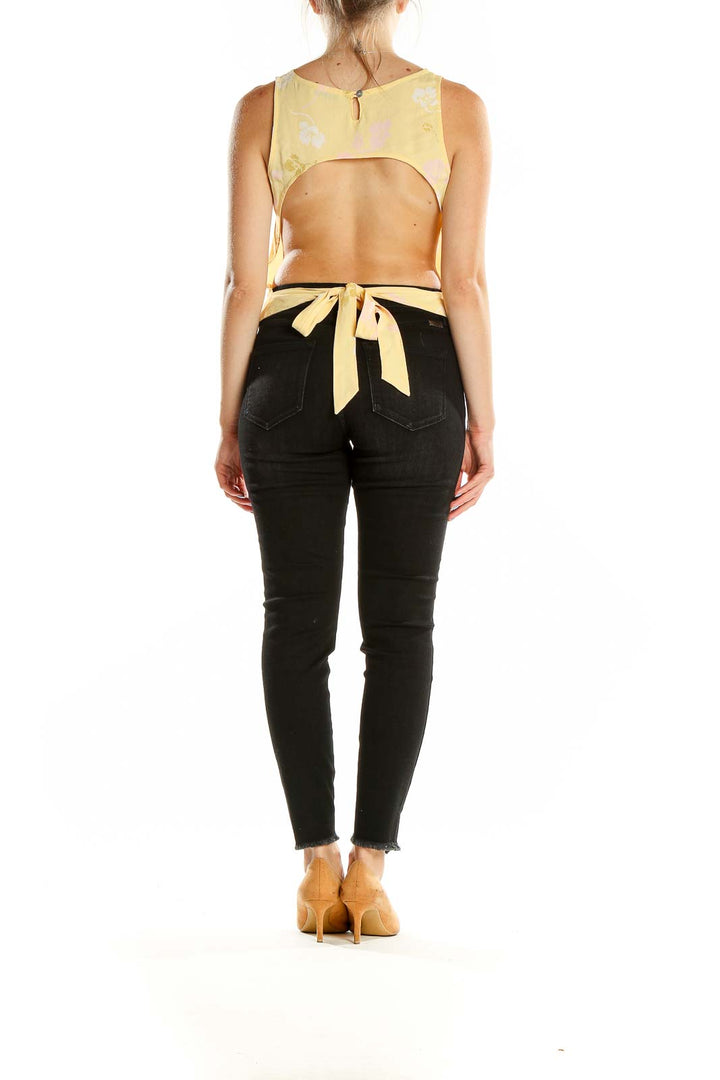 Back view of Monte yellow floral sleeveless crop top with tie closure