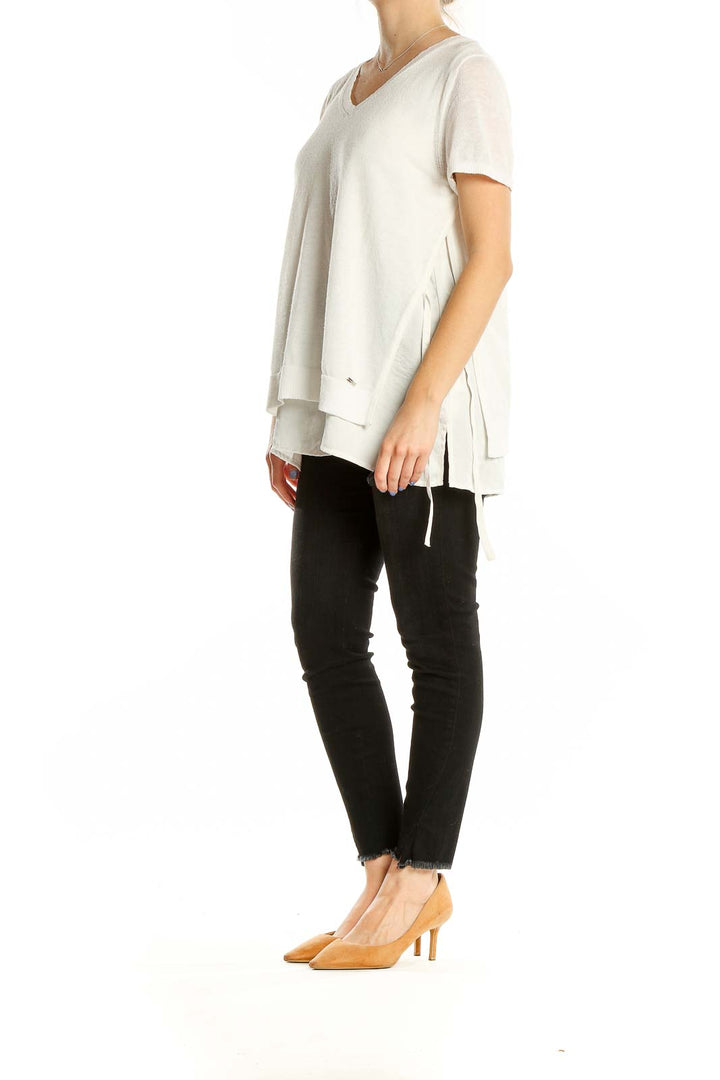 Front view of DKNY white layered V-neck top with side ties