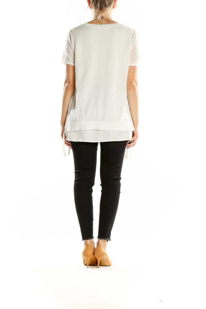 Back view of DKNY white layered top showing relaxed fit