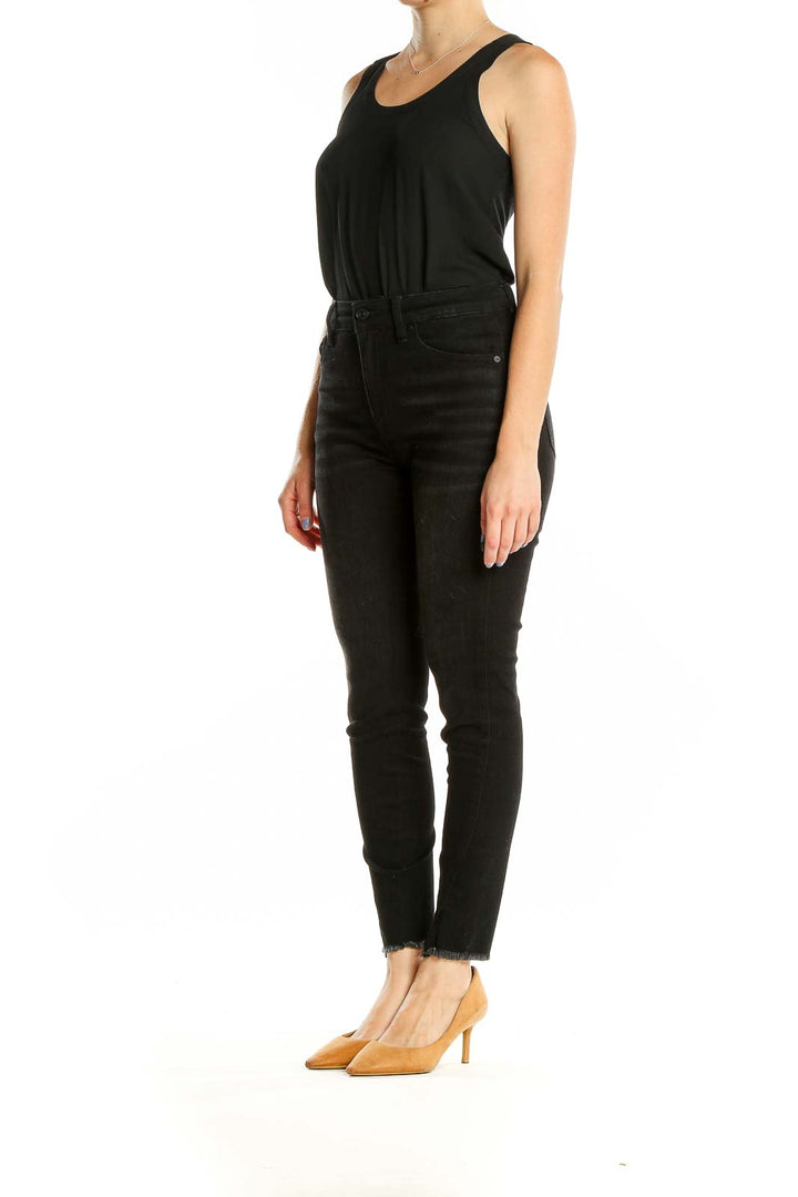 Front view of Kancan black high-waisted skinny jeans with raw hem