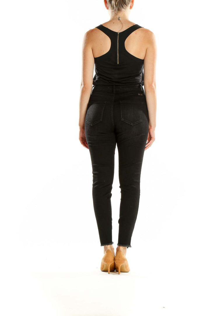 Back view of Kancan black high-waisted skinny jeans on model