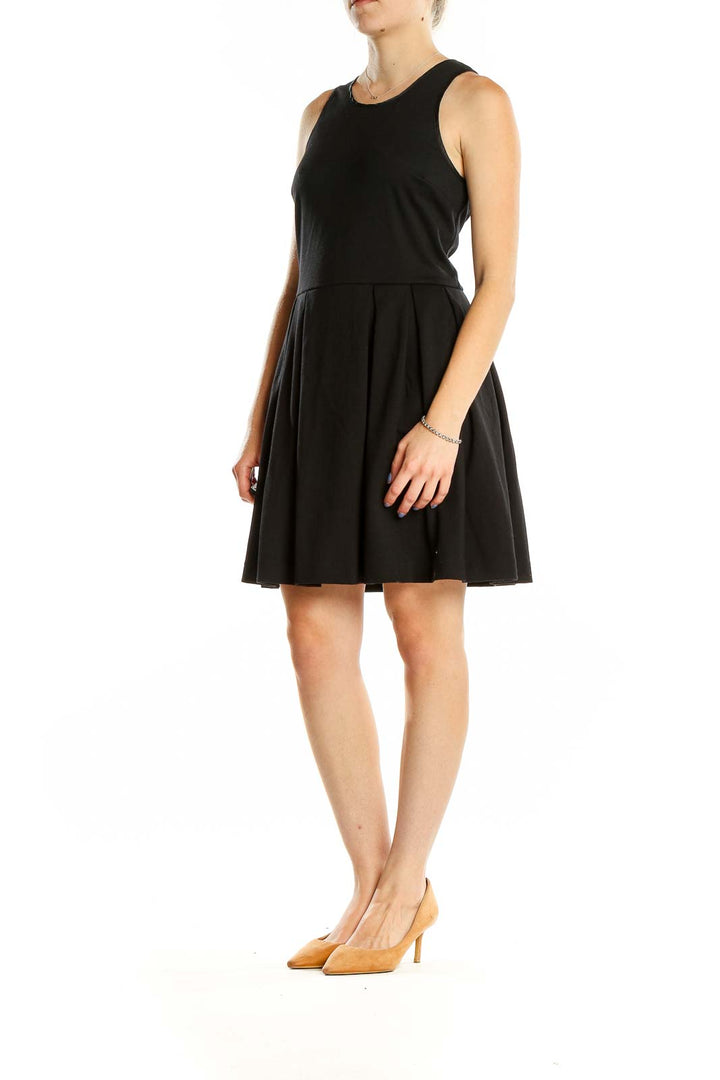 Front view of black Juicy Couture sleeveless cocktail dress with pleated skirt