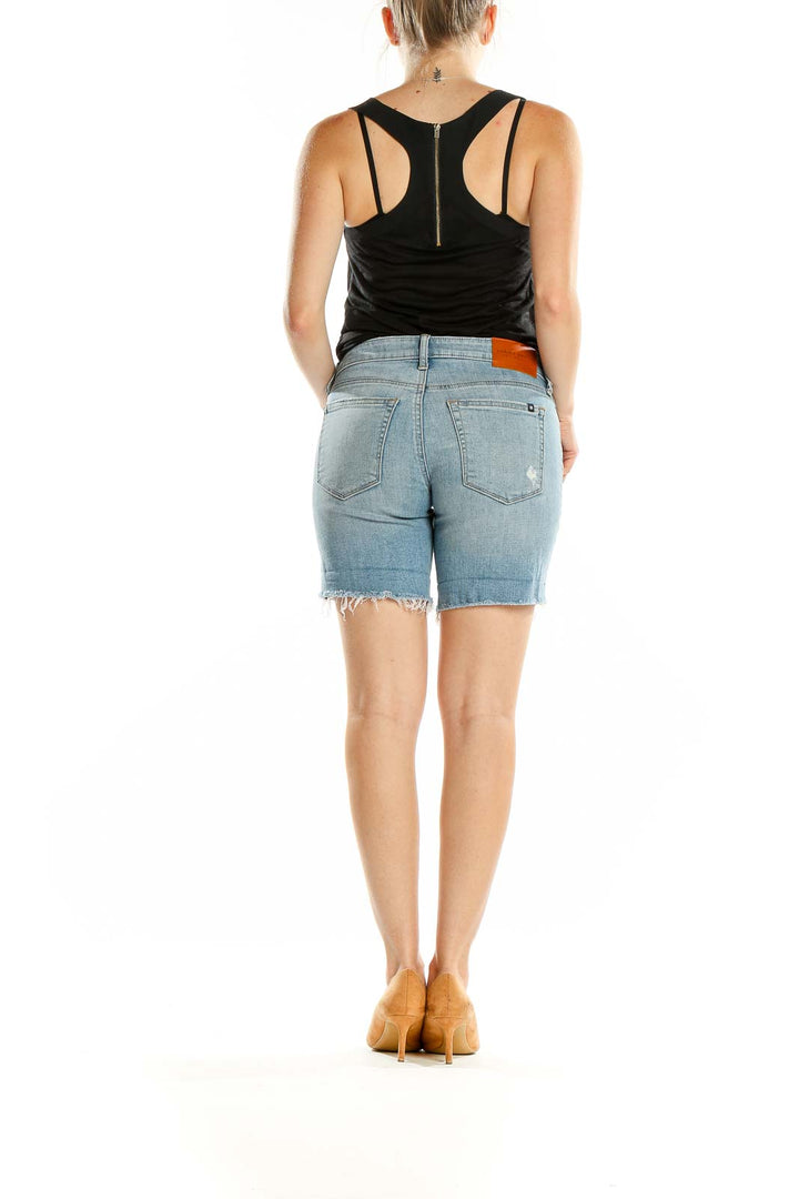 Back view of Lucky Brand light blue denim shorts on model with black top