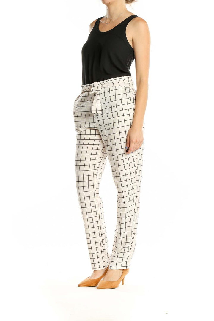 Front view of HAVE white grid pattern pants with straight leg design