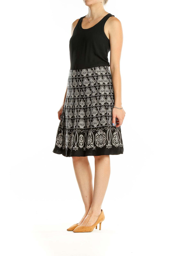 Front view of Ann Taylor black A-line skirt with white embroidery pattern