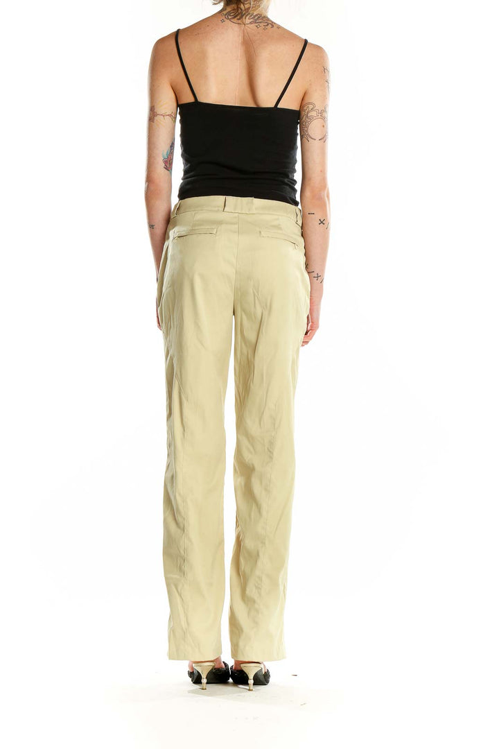 Back view of pale yellow Greg Norman activewear pants showing straight-leg design