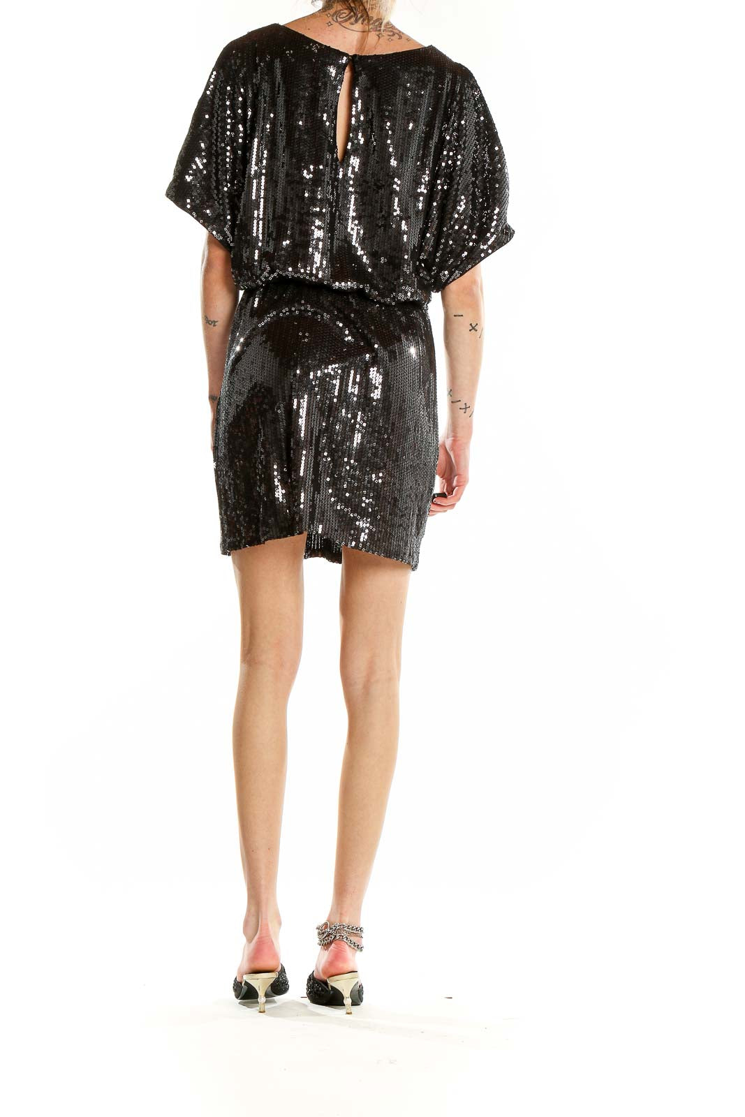 Back view of Xscape black sequin mini dress showing keyhole detail