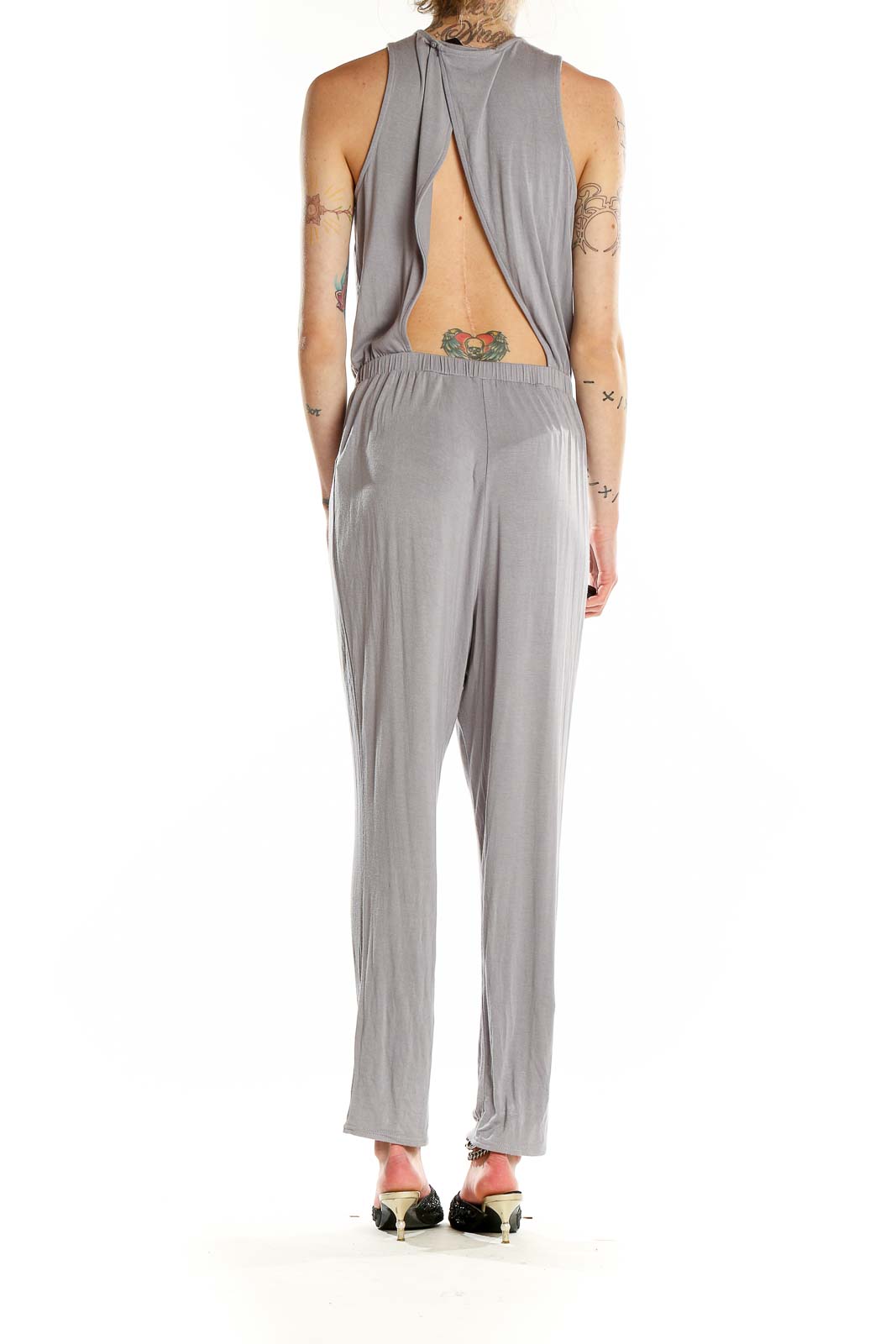 Back view of gray jumpsuit showing open back design