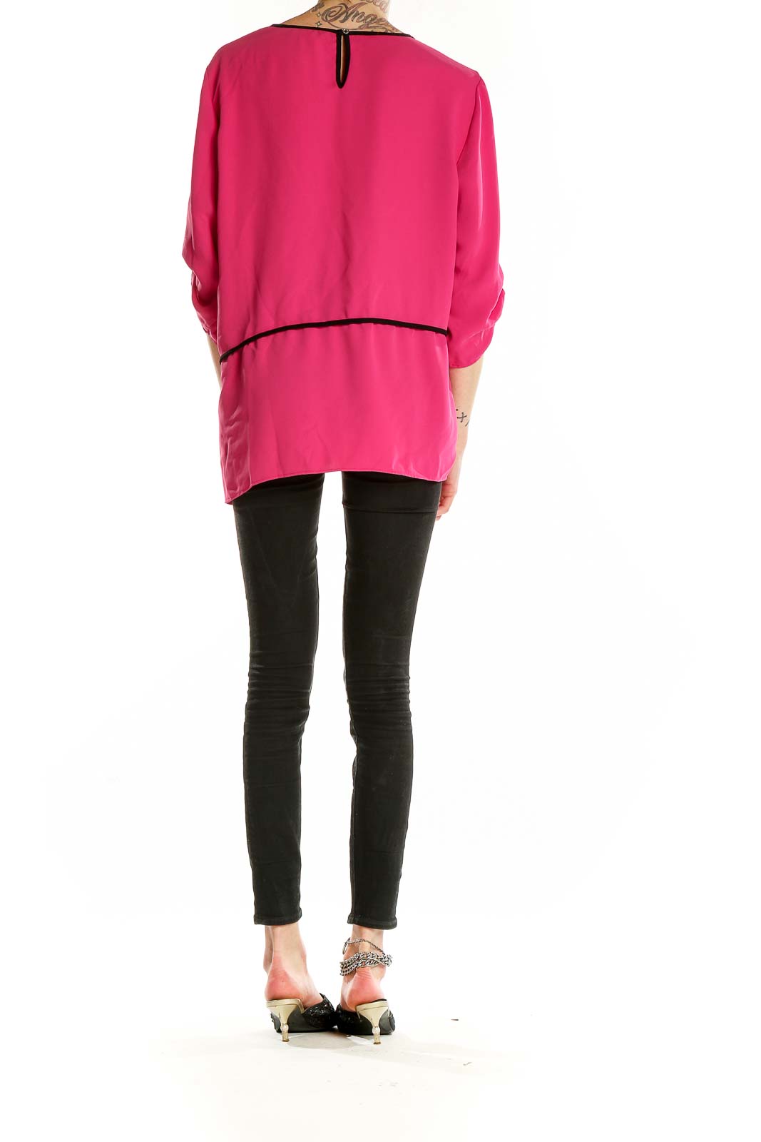 Back view of hot pink Calvin Klein blouse showing relaxed fit and high-low hem