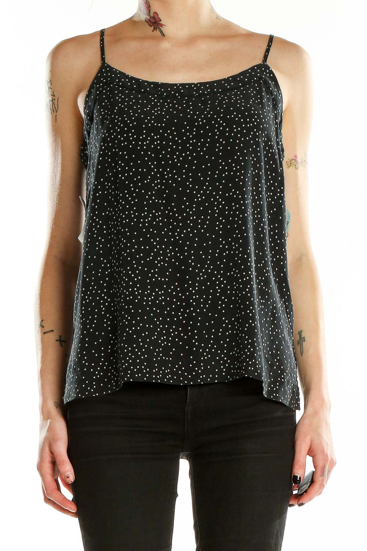 Front view of Madewell black silk camisole with white polka dots