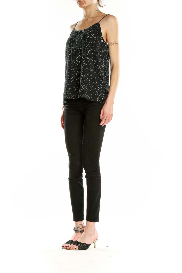 Front view of Madewell black silk camisole with white polka dots