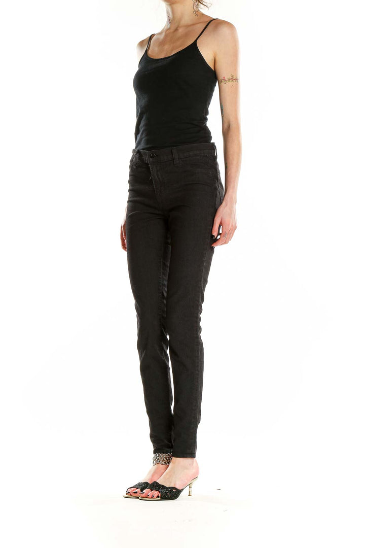 Front view of J Brand black skinny high-rise jeans on model