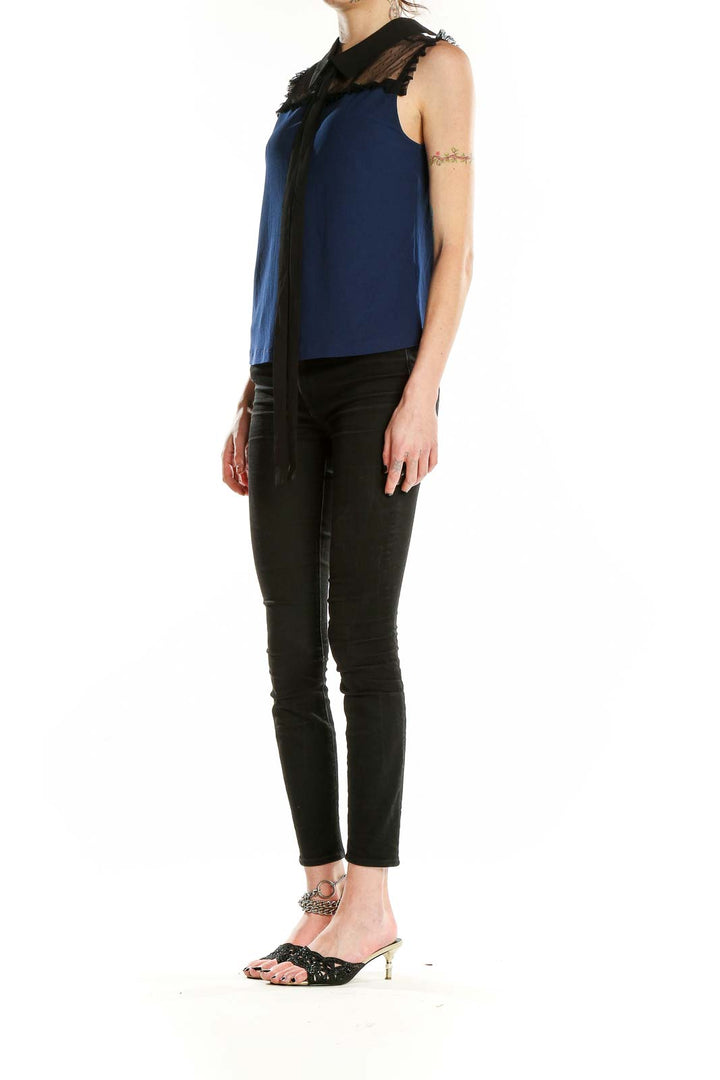 Front view of CeCe navy sleeveless blouse with sheer lace yoke and black collar