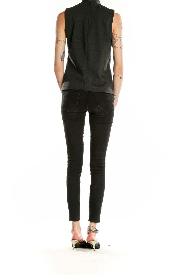 Back view of J.Crew charcoal mock neck sleeveless top on model with skinny jeans