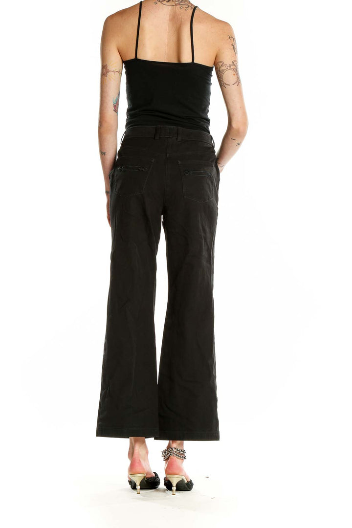 Back view of St. John Caviar black wide-leg trousers on model