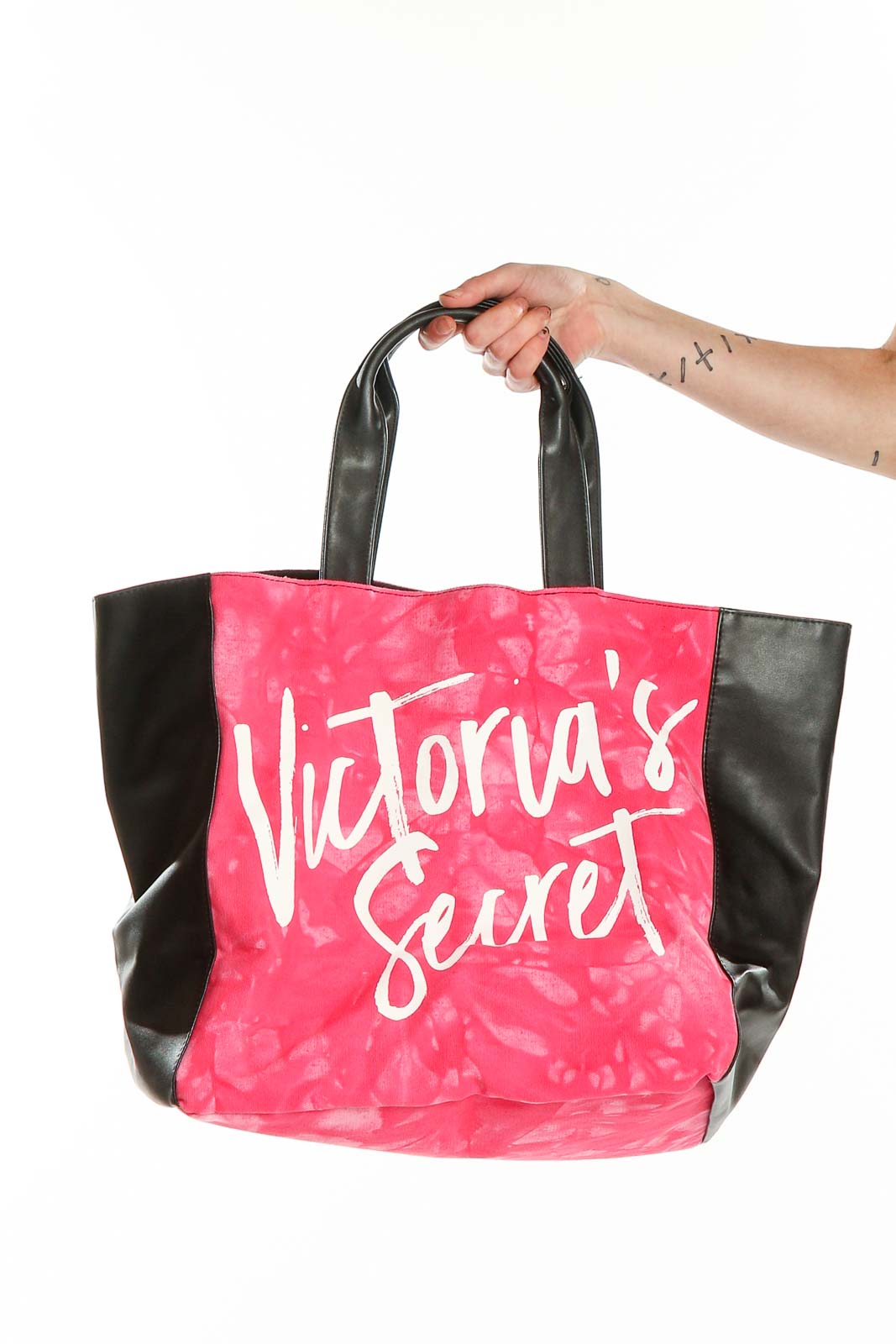 Front view of pink Victoria's Secret tote bag with black sides and handles