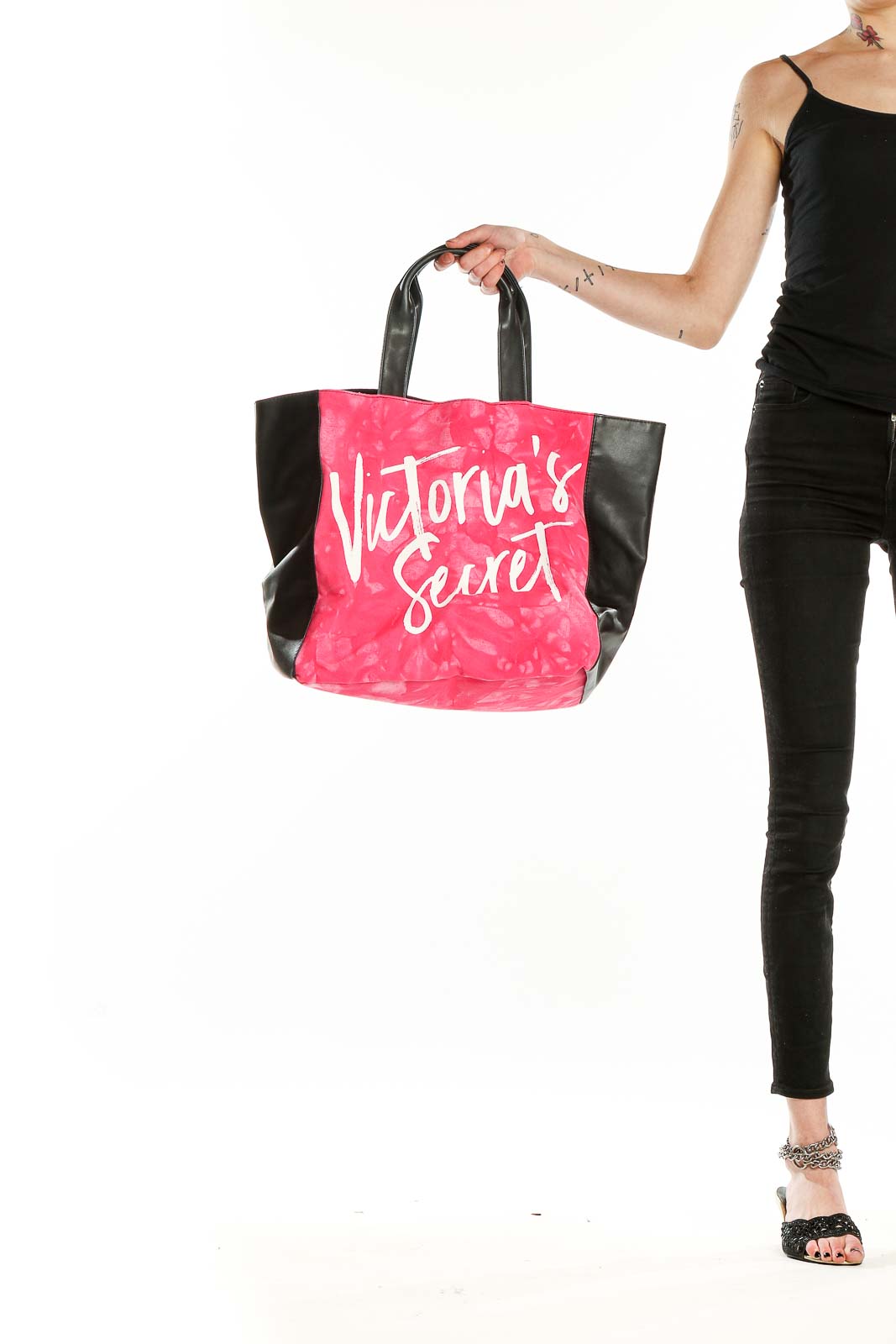 Front view of pink Victoria's Secret tote bag with black sides and handles